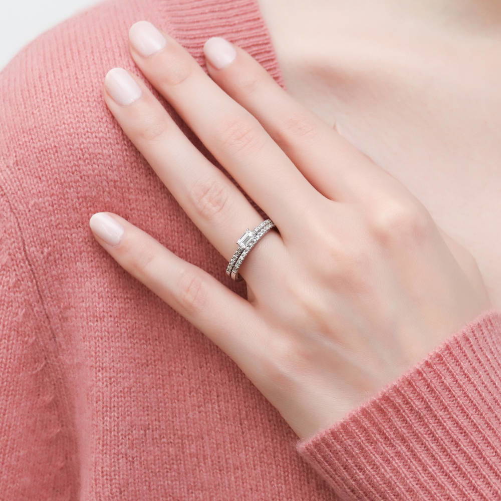 Model wearing Solitaire East-West 0.3ct Emerald Cut CZ Ring in Sterling Silver, 9 of 12