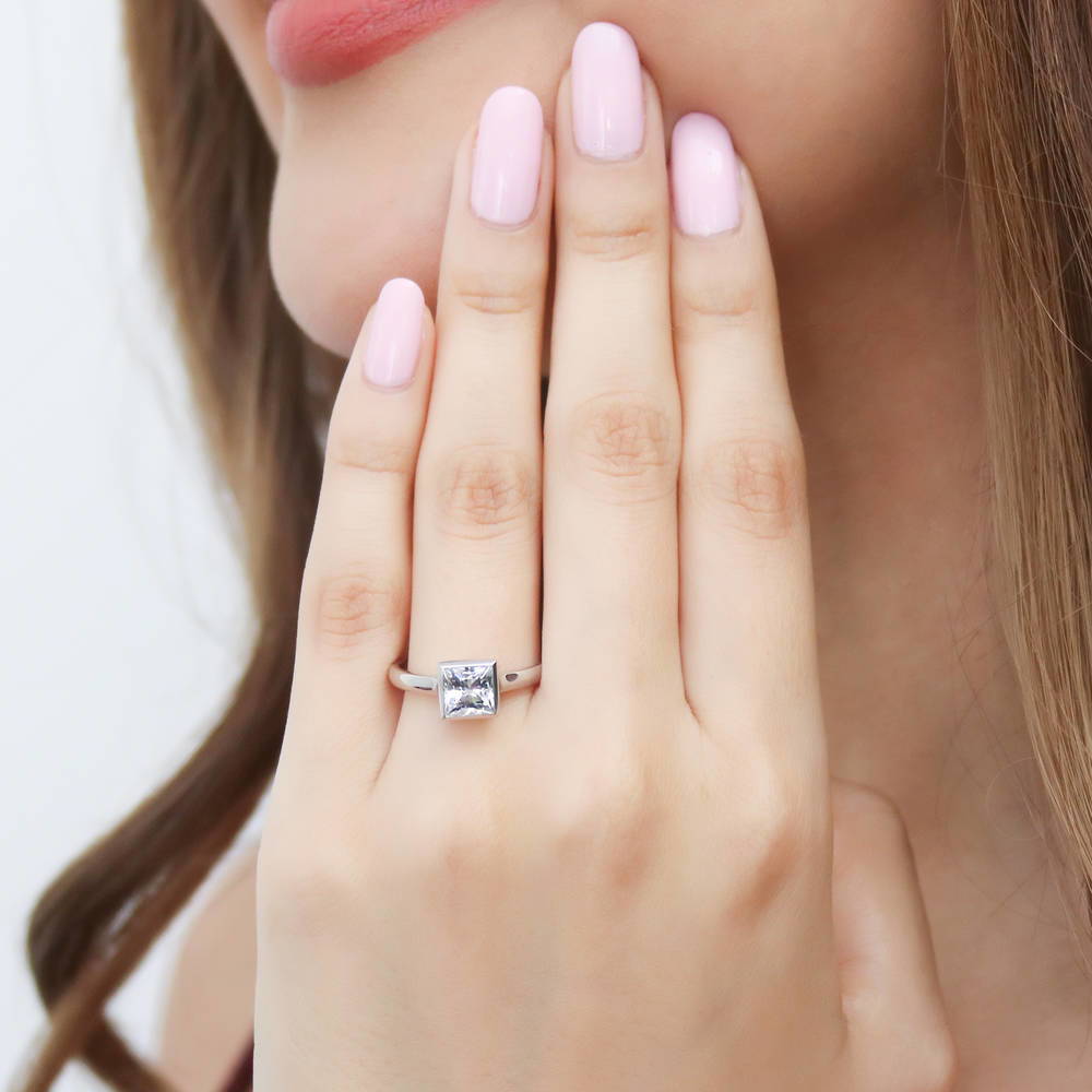 Model wearing Solitaire 1.2ct Bezel Princess CZ Ring in Sterling Silver, 2 of 8