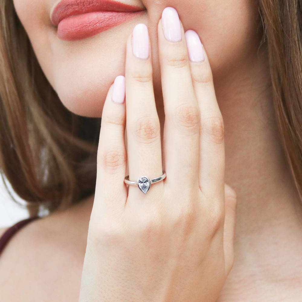 Model wearing Solitaire 0.8ct Bezel Pear CZ Ring in Sterling Silver, 2 of 8