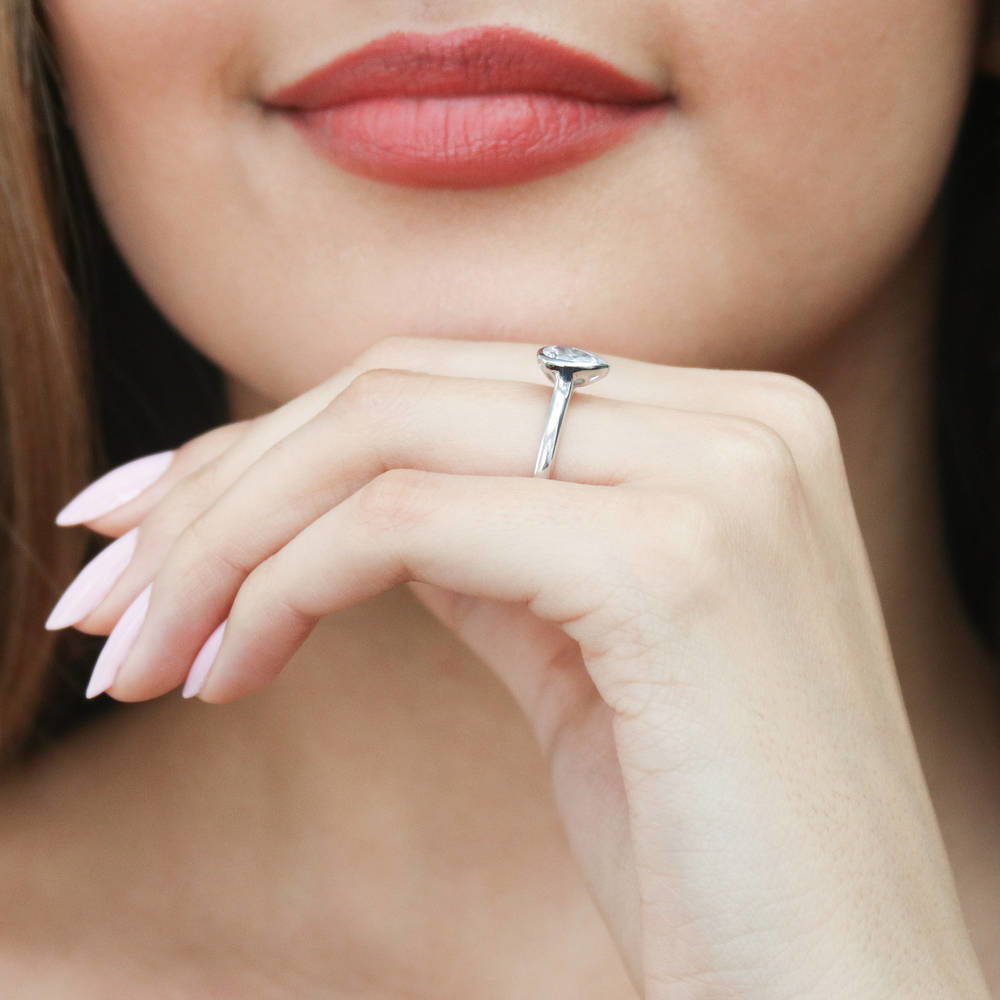 Model wearing Solitaire 0.8ct Bezel Set Pear CZ Ring in Sterling Silver, 6 of 8