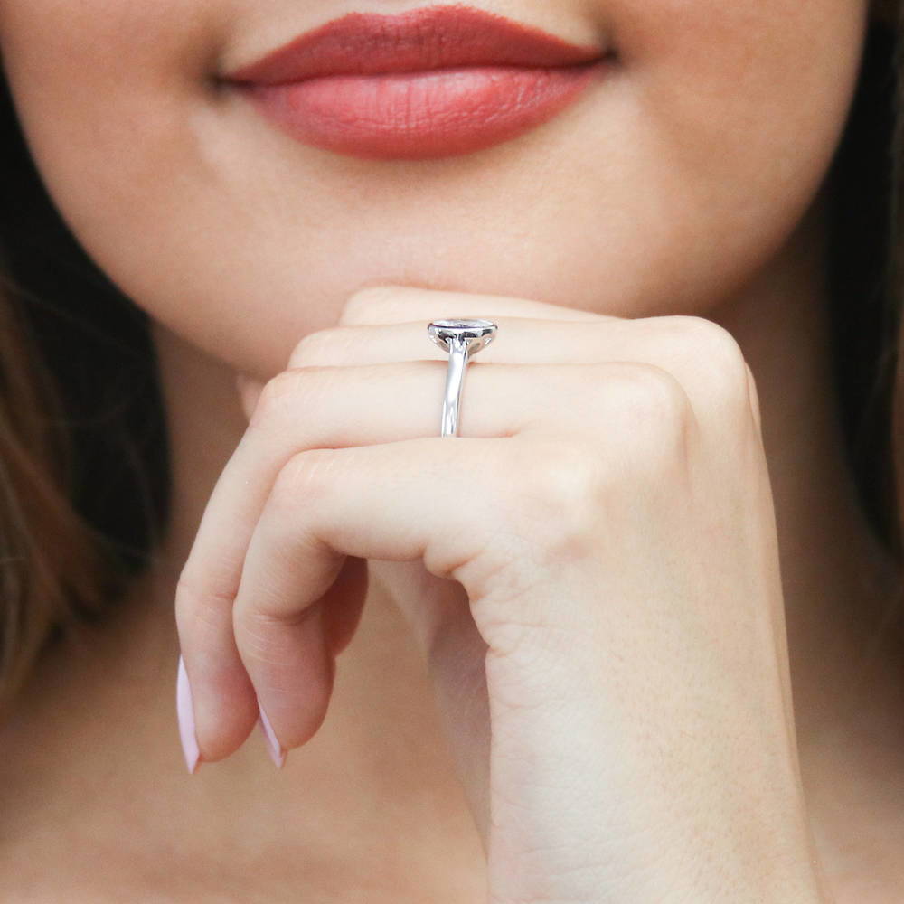 Model wearing Solitaire 1.2ct Bezel Oval CZ Ring in Sterling Silver, 6 of 8