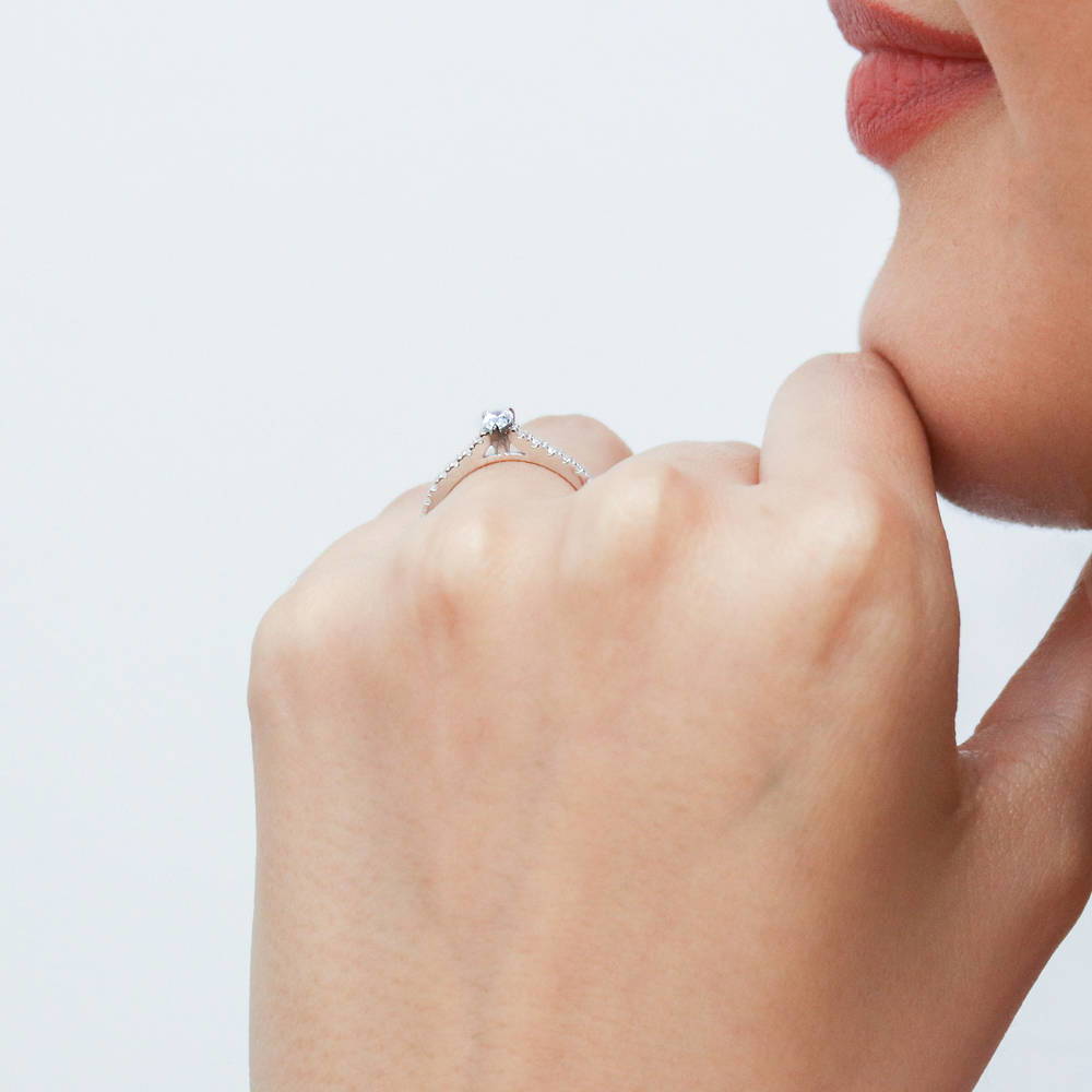Model wearing Solitaire 0.3ct Pear CZ Ring in Sterling Silver, 6 of 11