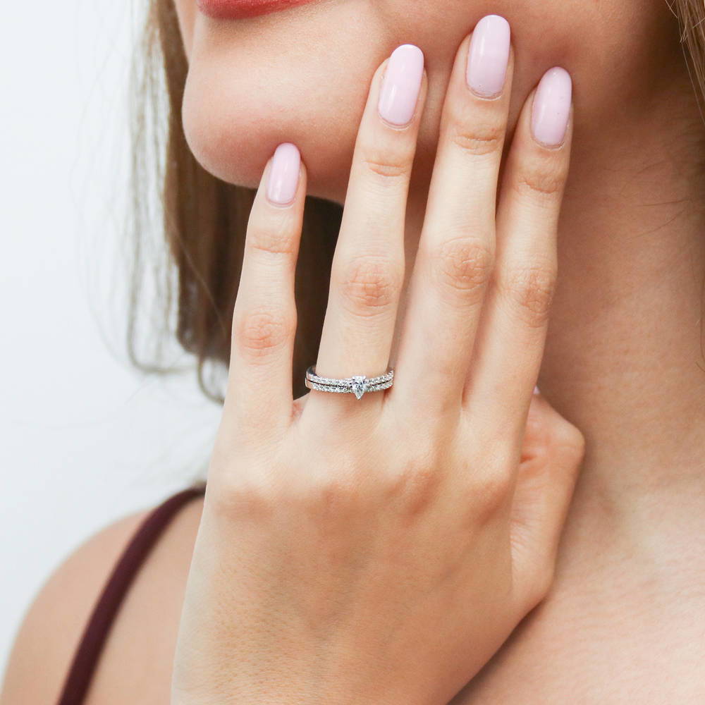 Model wearing Solitaire 0.3ct Pear CZ Ring in Sterling Silver, 11 of 14