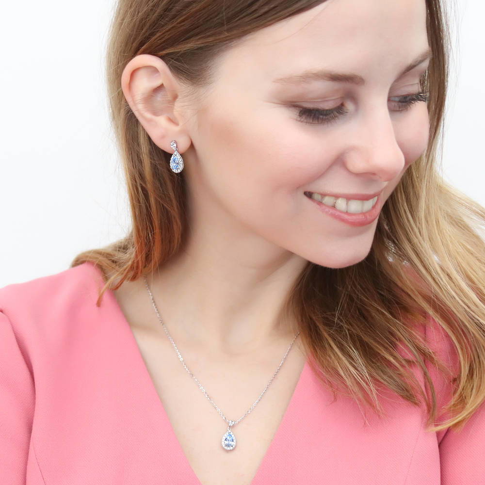 Model wearing Halo Pear CZ Dangle Earrings in Sterling Silver, 14 of 16