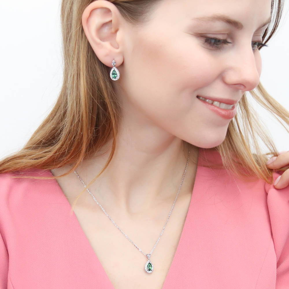 Model wearing Halo Pear CZ Dangle Earrings in Sterling Silver, 12 of 16