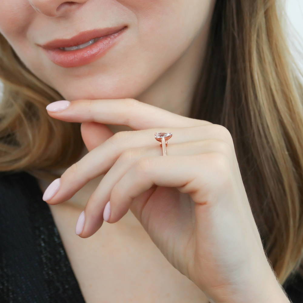Model wearing Solitaire 0.8ct Pear CZ Ring in Rose Gold Plated Sterling Silver, 6 of 8