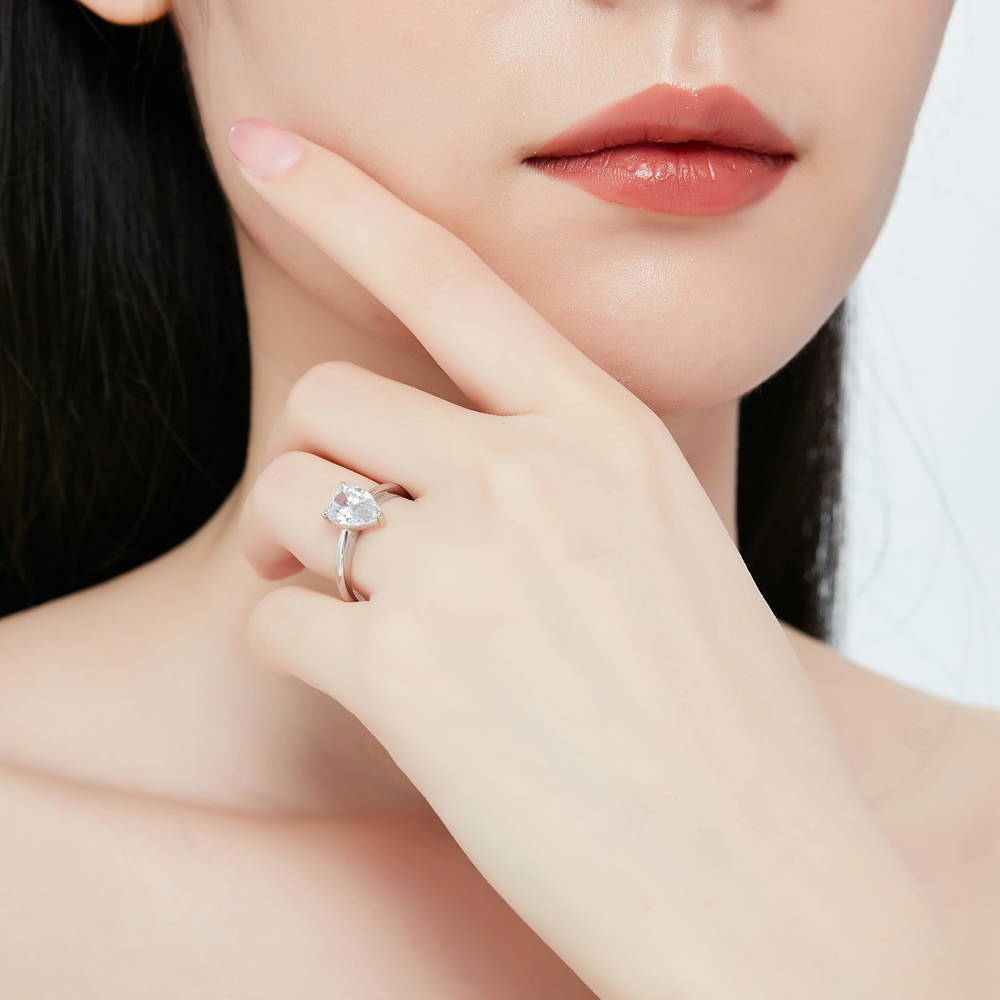Model wearing Solitaire 1.8ct Pear CZ Ring in Sterling Silver, 7 of 12
