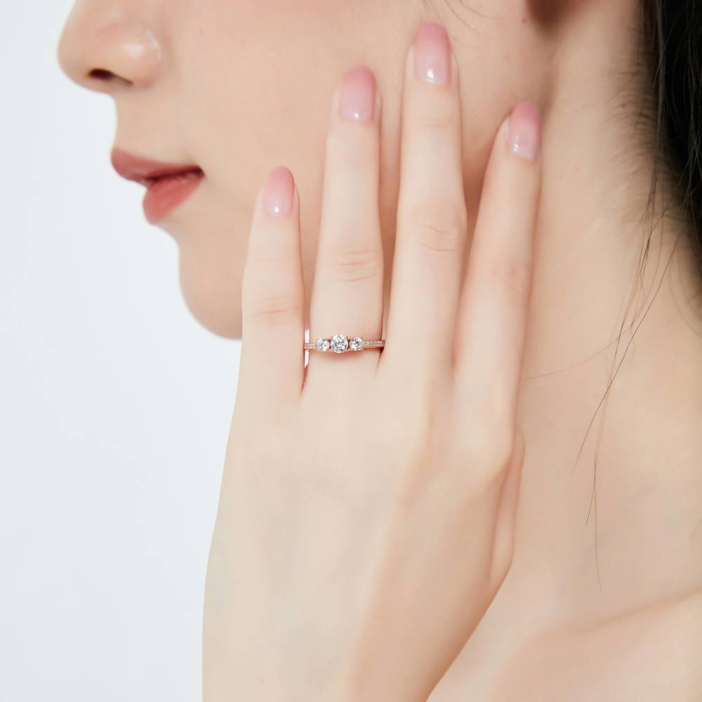 Model wearing 3-Stone Round CZ Ring in Rose Gold Plated Sterling Silver, 2 of 10
