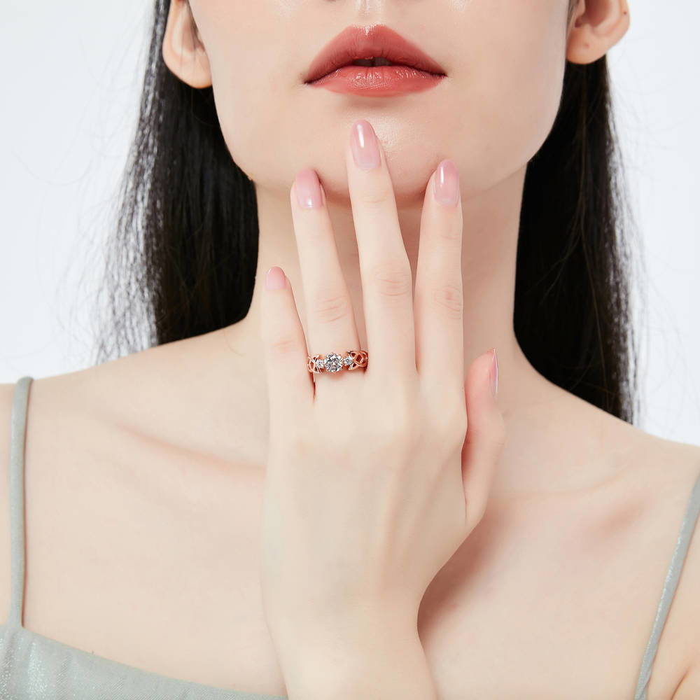 Model wearing Celtic Knot 3-Stone CZ Ring in Rose Gold Plated Sterling Silver, 2 of 8