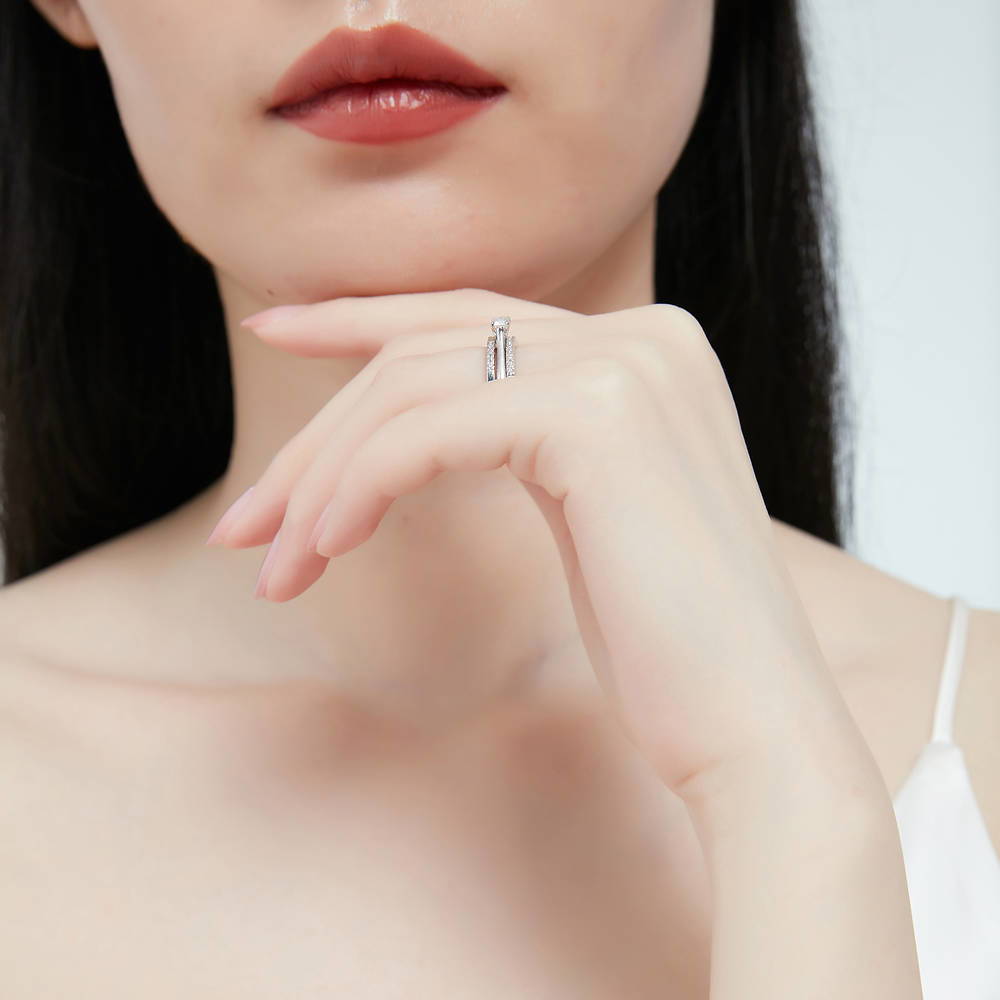 Model wearing Solitaire East-West 0.3ct Emerald Cut CZ Ring in Sterling Silver, 13 of 14