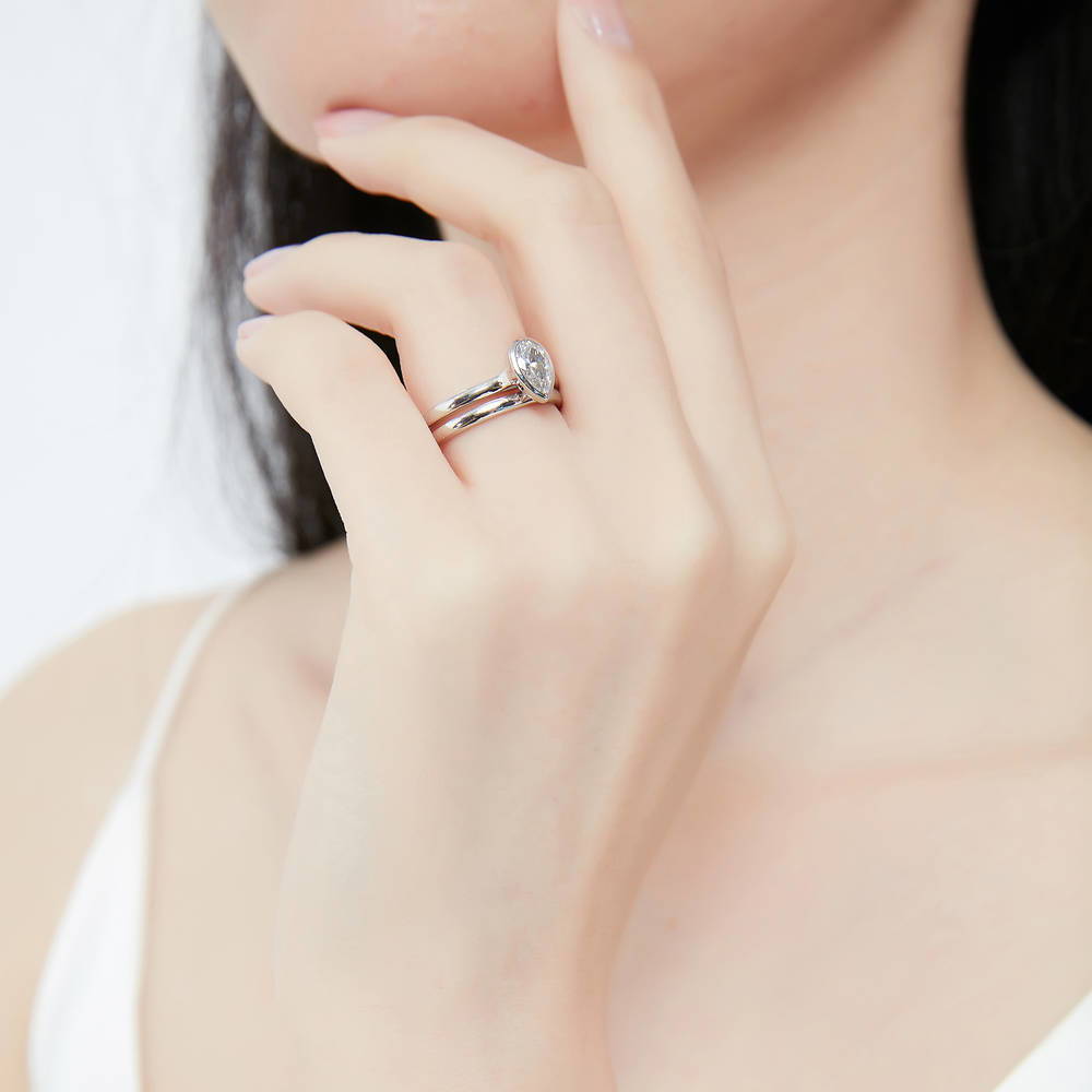Model wearing Solitaire 0.8ct Bezel Set Pear CZ Ring Set in Sterling Silver, 6 of 13