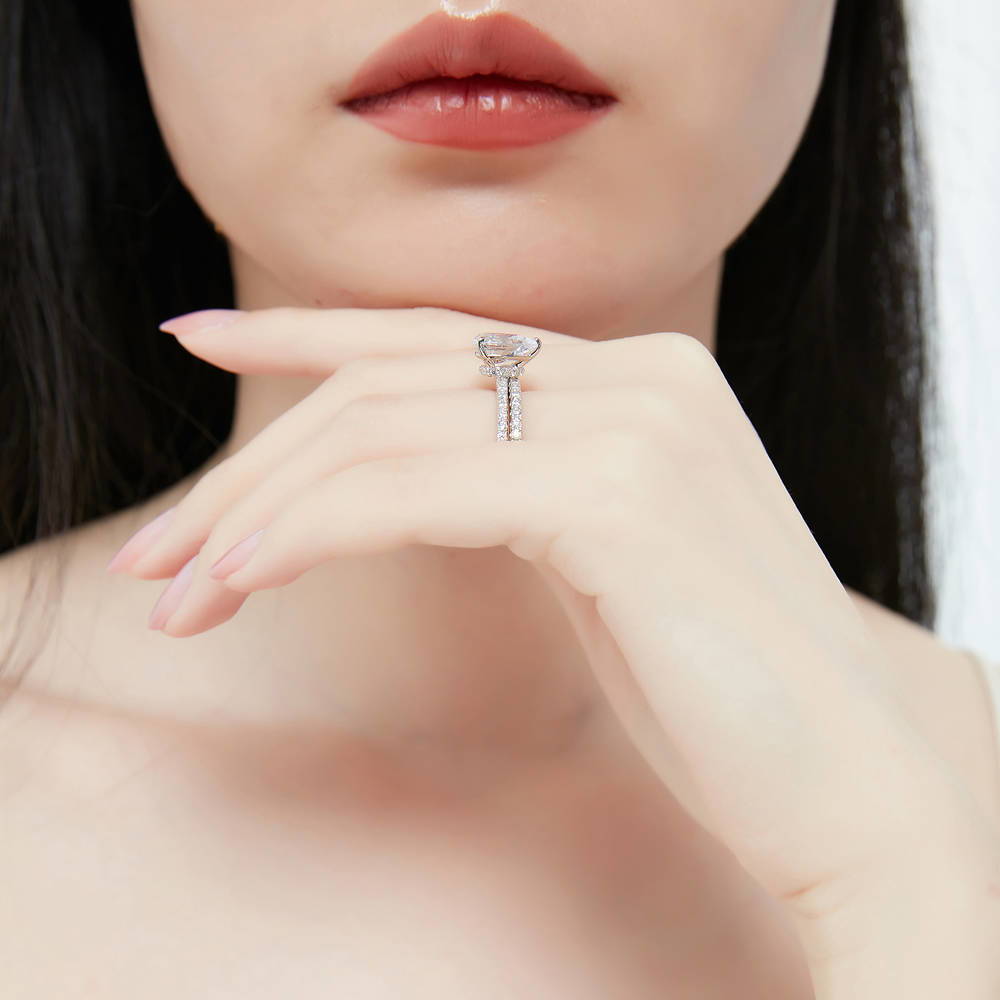 Model wearing Solitaire Hidden Halo 1.8ct Pear CZ Ring Set in Sterling Silver, 7 of 13