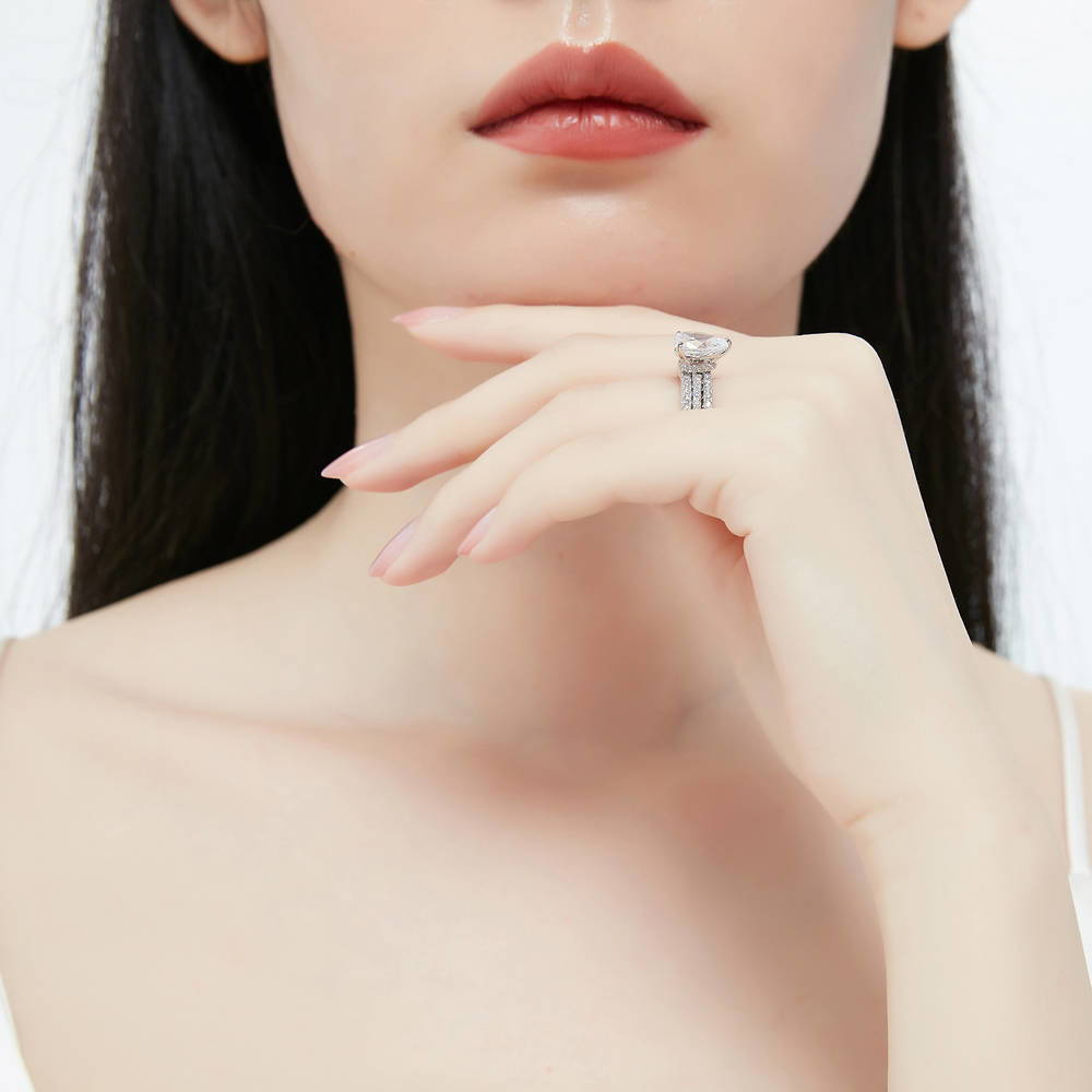 Model wearing Solitaire Hidden Halo 1.8ct Pear CZ Ring Set in Sterling Silver, 7 of 13