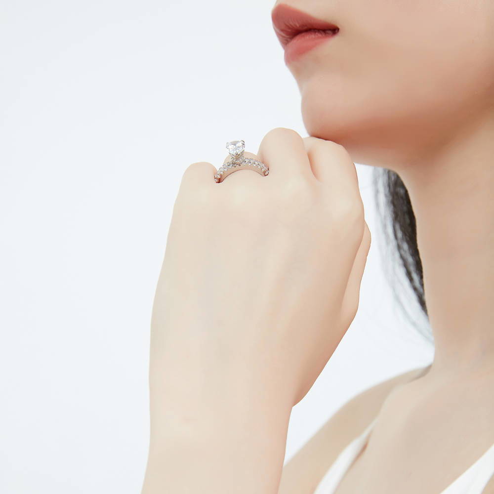 Model wearing Solitaire Hidden Halo 1.8ct Pear CZ Ring Set in Sterling Silver, 6 of 13