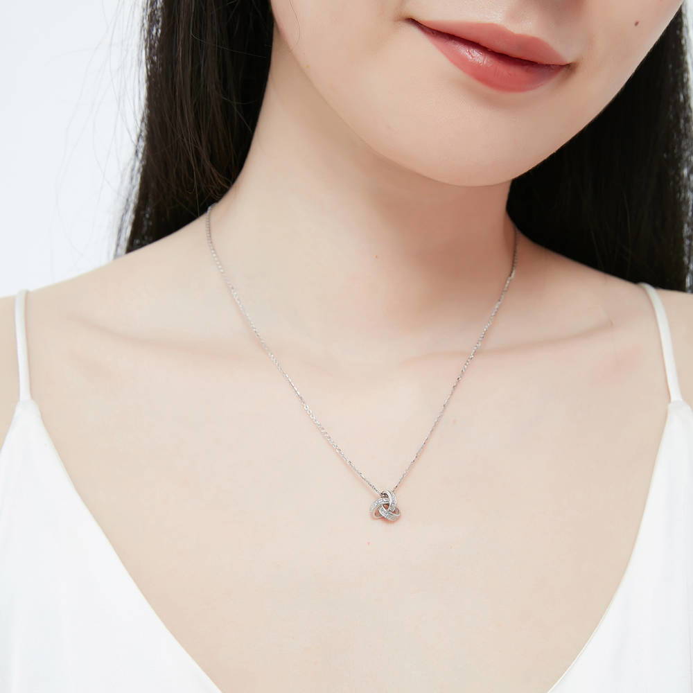 Model wearing Love Knot CZ Necklace and Earrings in Sterling Silver, 10 of 15