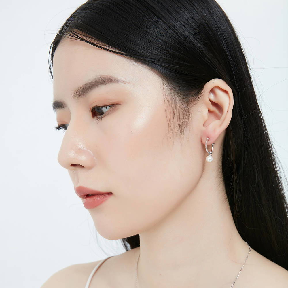 Model wearing Solitaire Imitation Pearl Earrings in Sterling Silver, 2 of 4