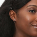 Model wearing Oval Bar CZ Small Hoop Earrings in Sterling Silver 0.6 inch, Yellow Gold Flashed
