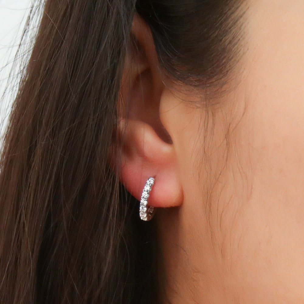 Model wearing 7-Stone CZ Small Hoop Earrings in Sterling Silver 0.6 inch, 2 of 7