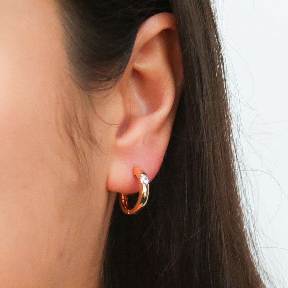 Model wearing Solitaire CZ Small Hoop Earrings in Sterling Silver 0.6 inch, Gold Flashed