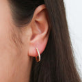 Model wearing Oval Bar CZ Small Hoop Earrings in Sterling Silver 0.6 inch, Yellow Gold Flashed