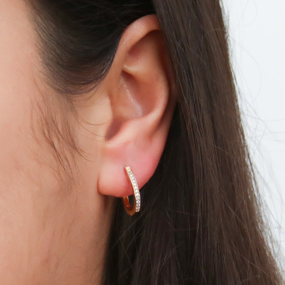 Model wearing Oval Bar CZ Small Hoop Earrings in Sterling Silver 0.6 inch, Yellow Gold Flashed