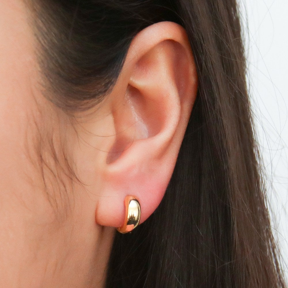 Model wearing Dome Huggie Earrings in Gold Flashed Sterling Silver, 2 Pairs, 2 of 13