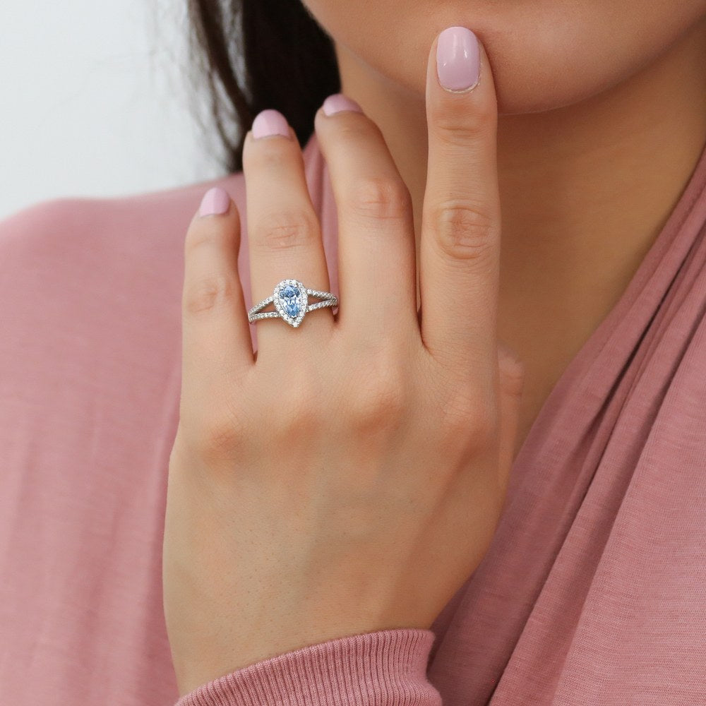 Model wearing Halo Blue Pear CZ Split Shank Ring in Sterling Silver, 2 of 9