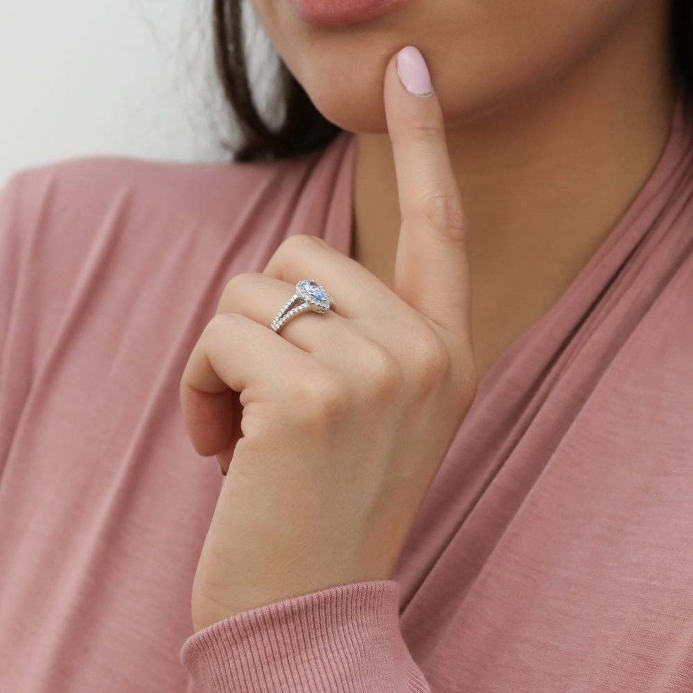 Model wearing Halo Blue Pear CZ Split Shank Ring in Sterling Silver, 6 of 10