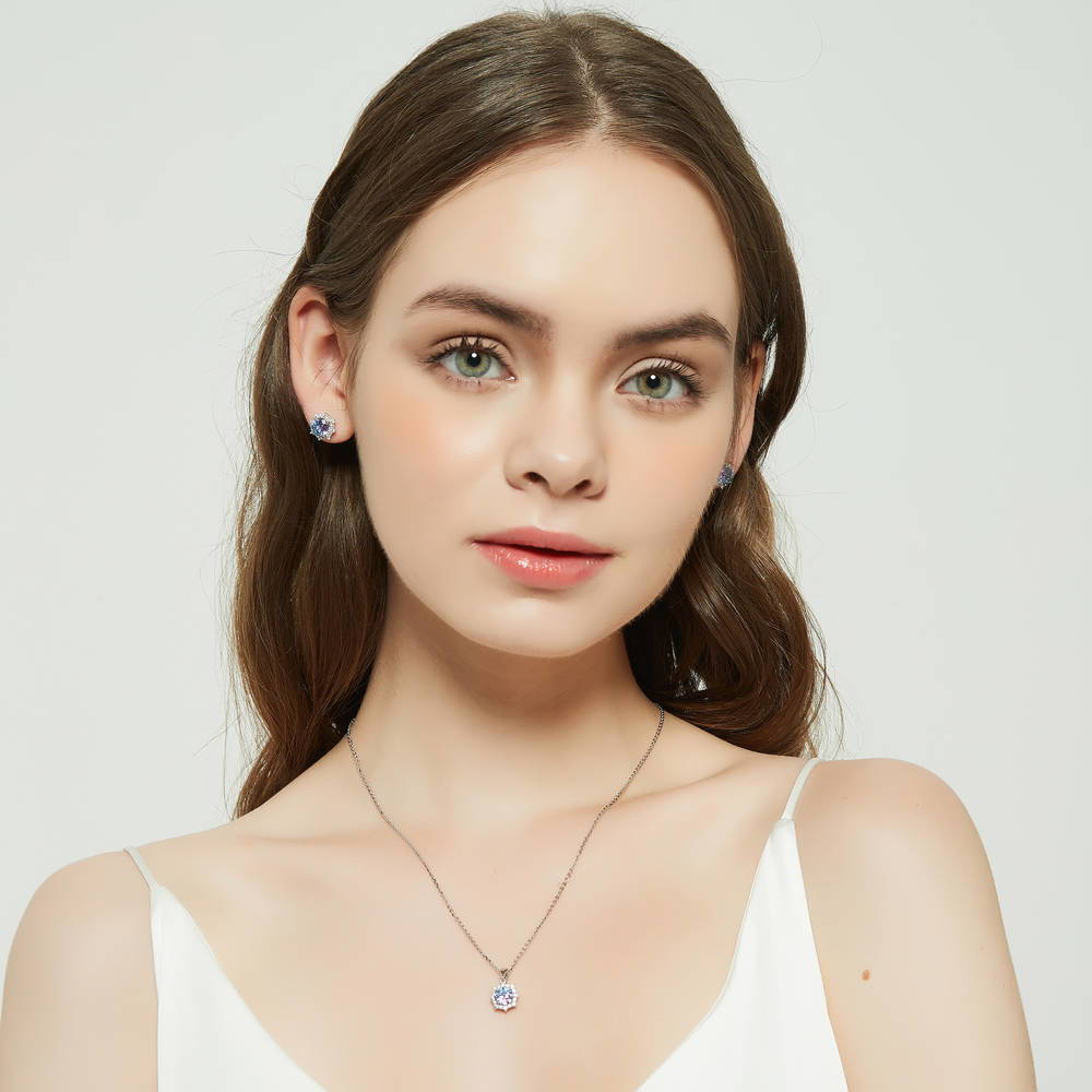 Model wearing Sunburst Halo CZ Stud Earrings in Sterling Silver, Purple Aqua Color