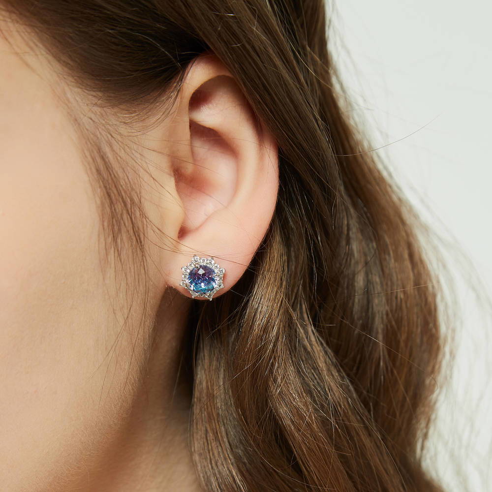 Model wearing Sunburst Halo CZ Stud Earrings in Sterling Silver, Purple Aqua Color