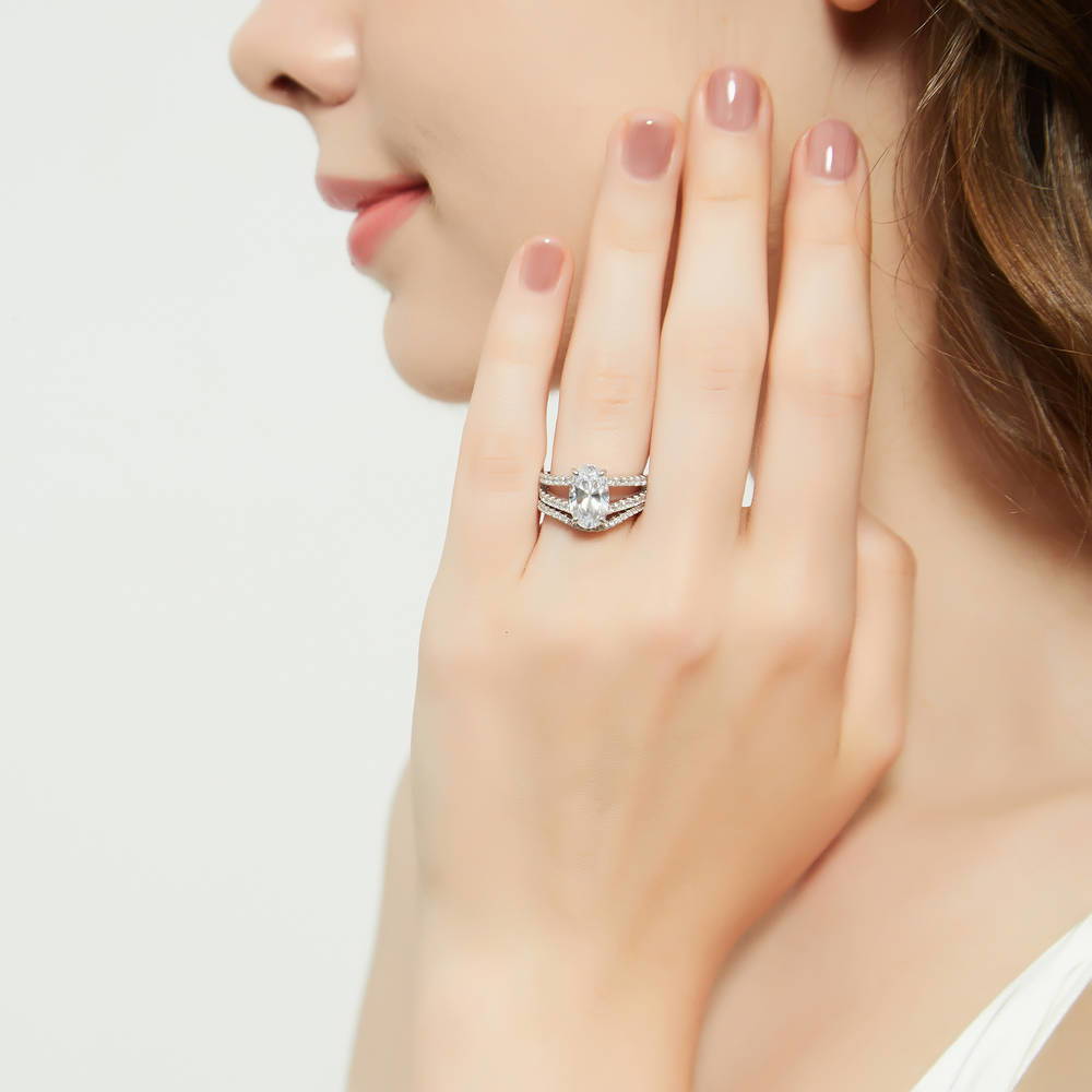 Model wearing Solitaire 2.7ct Oval CZ Split Shank Ring Set in Sterling Silver, 3 of 17