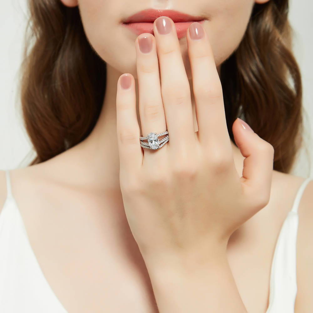 Model wearing Solitaire 2.7ct Oval CZ Split Shank Ring Set in Sterling Silver, 2 of 17