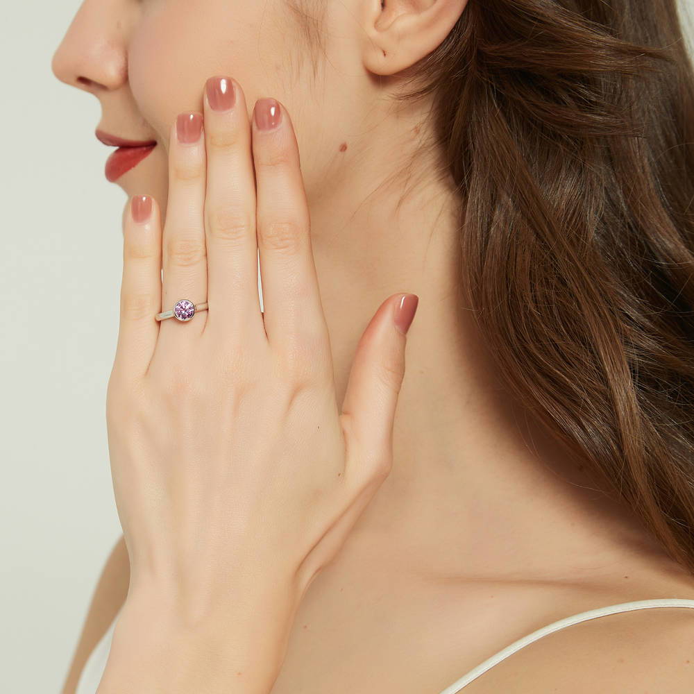 Model wearing Solitaire 0.8ct Purple Bezel CZ Ring Set in Sterling Silver, 7 of 10