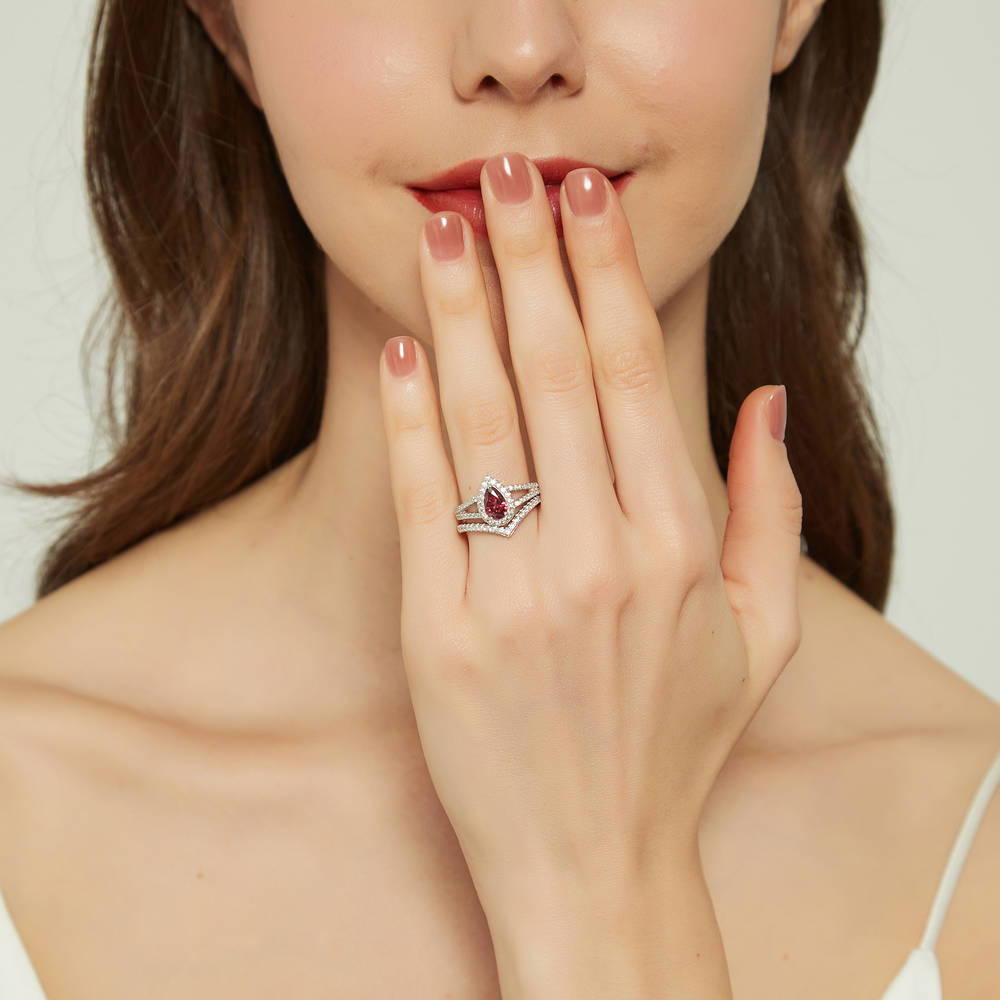 Model wearing Halo Wishbone Red Pear CZ Split Shank Ring Set in Sterling Silver, 2 of 16