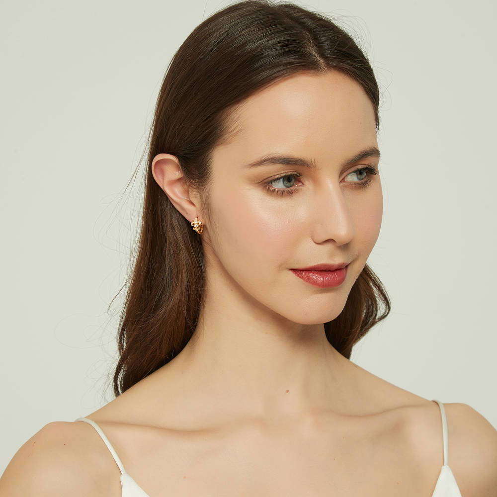 Model wearing Fleur De Lis CZ Small Huggie Earrings in Sterling Silver 0.5 inch, 9 of 14