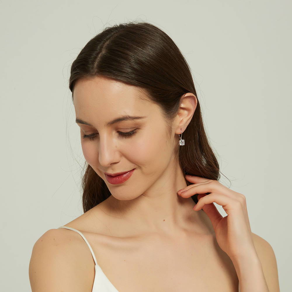 Model wearing Solitaire 6ct Cushion CZ Leverback Dangle Earrings in Sterling Silver, 3 of 6