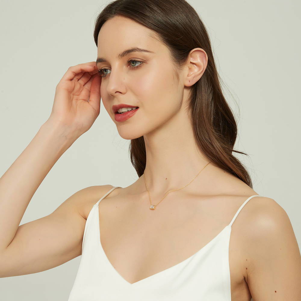 Model wearing Solitaire East-West CZ Necklace in Gold Flashed Sterling Silver, 5 of 9