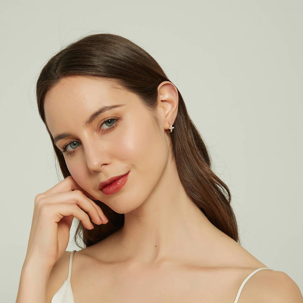 Model wearing Cross CZ Mini Huggie Earrings in Sterling Silver 0.5 inch, Gold Flashed