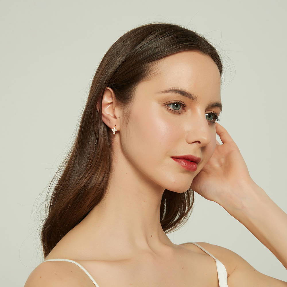 Model wearing Cross CZ Mini Huggie Earrings in Sterling Silver 0.5 inch, Gold Flashed