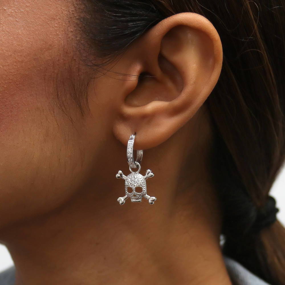 Model wearing Skull Bones CZ Dangle Earrings in Sterling Silver, 3 of 7