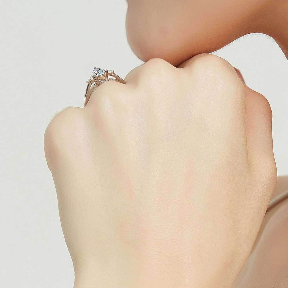 Model wearing 3-Stone Greyish Blue Pear CZ Ring in Sterling Silver, 7 of 9