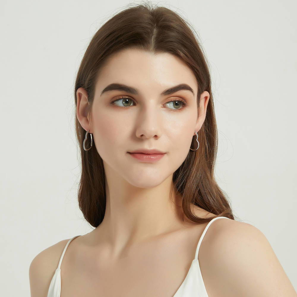 Model wearing Heart CZ Small Hoop Earrings in Sterling Silver 1 inch, 3 of 6