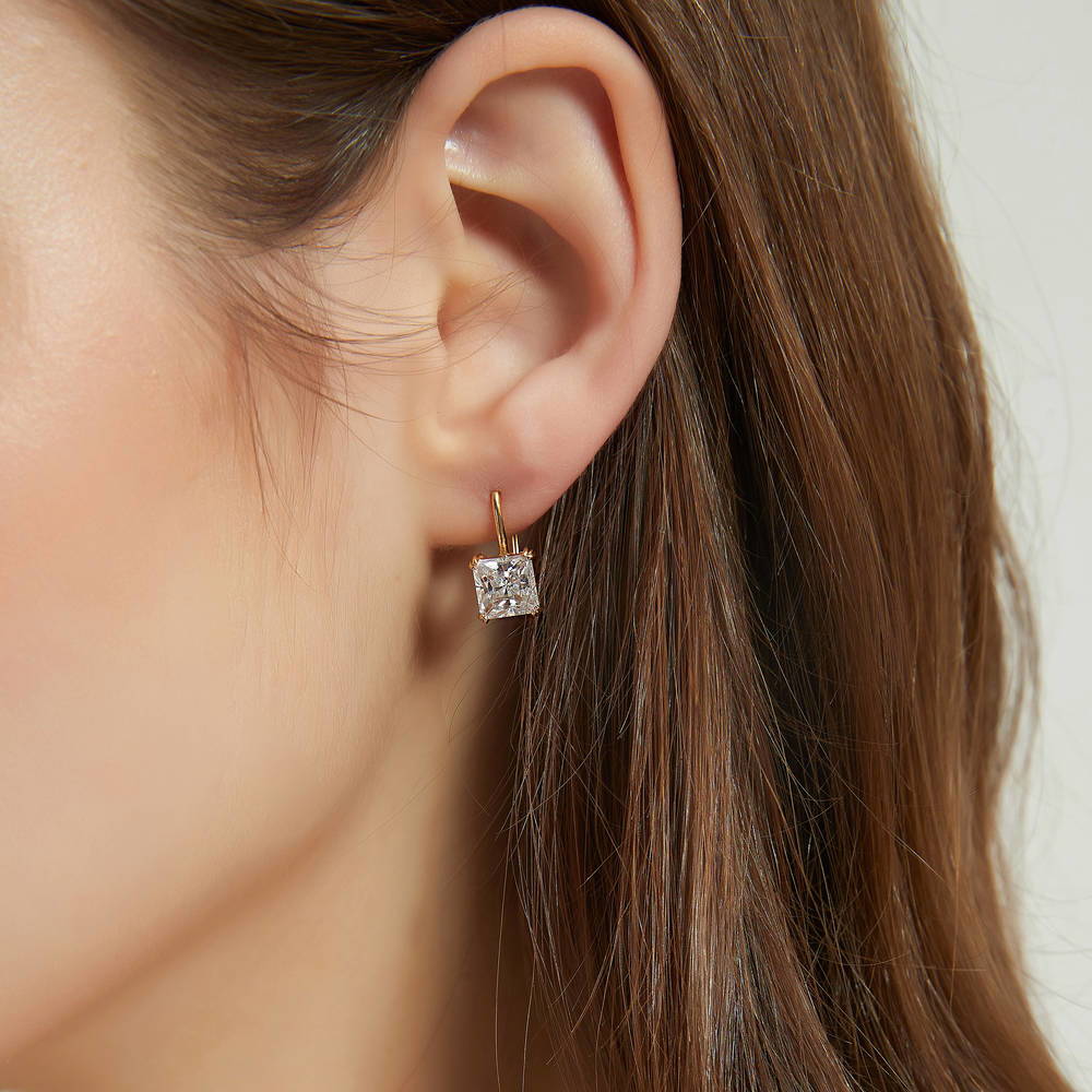 Model wearing Solitaire 4ct Princess CZ Leverback Dangle Earrings in Sterling Silver, 2 of 9