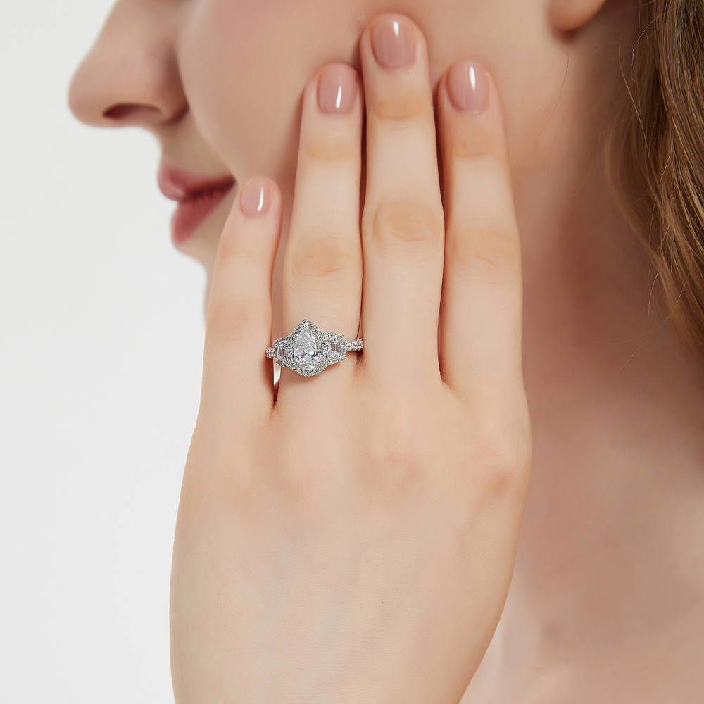 Model wearing 3-Stone Halo Pear CZ Ring in Sterling Silver, 2 of 10