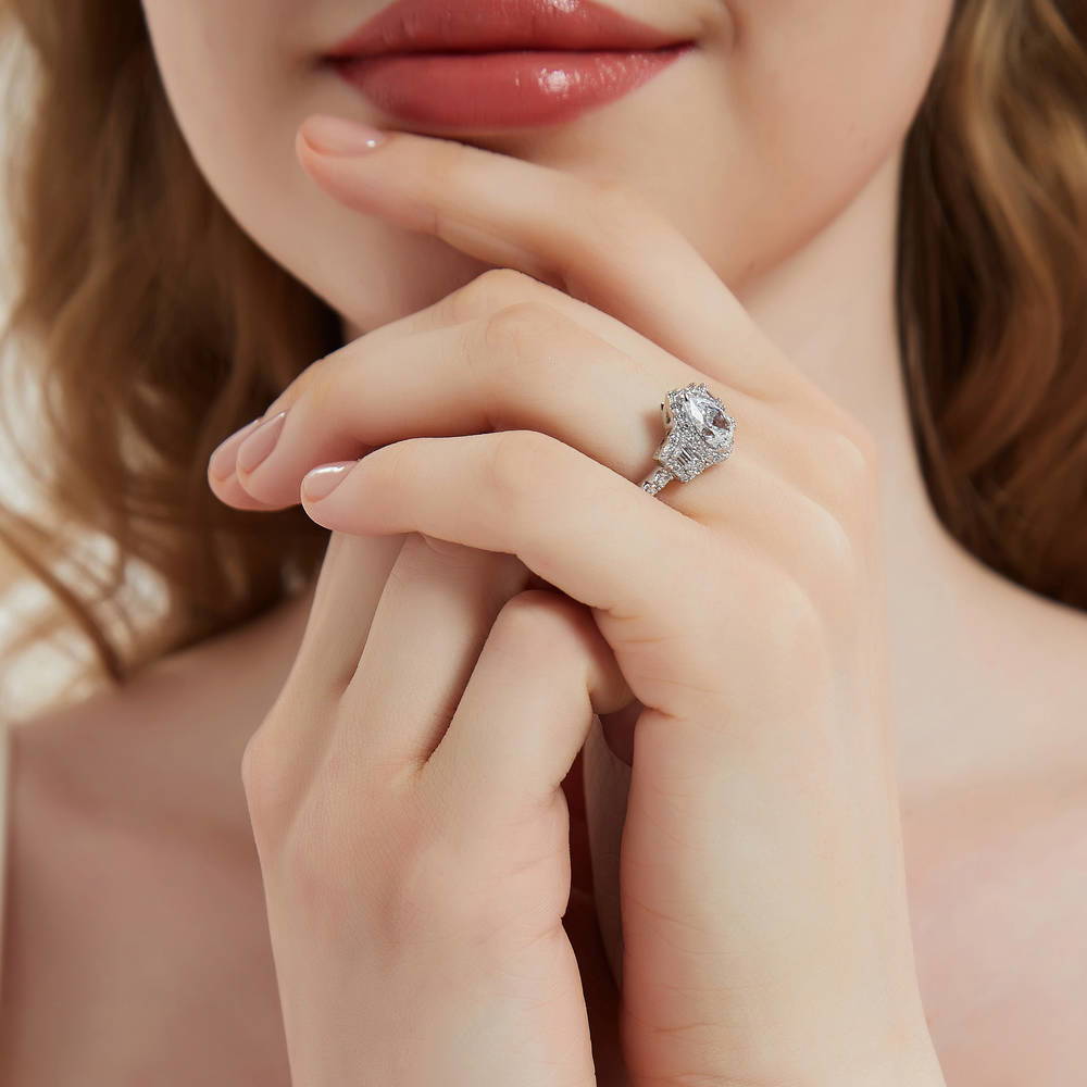 Model wearing 3-Stone Halo Pear CZ Ring in Sterling Silver, 3 of 10
