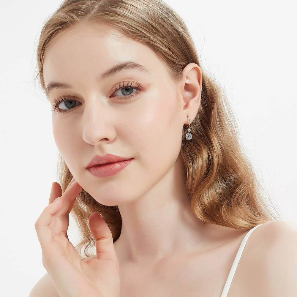 Model wearing Solitaire 2.5ct Round CZ Leverback Dangle Earrings in Sterling Silver, 3 of 5