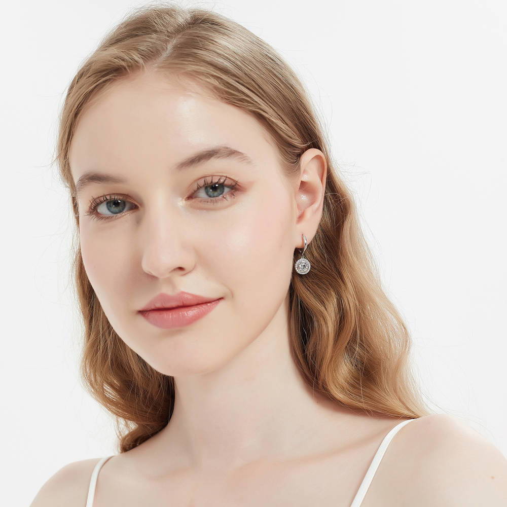 Model wearing Halo Round CZ Dangle Earrings in Sterling Silver, 3 of 5