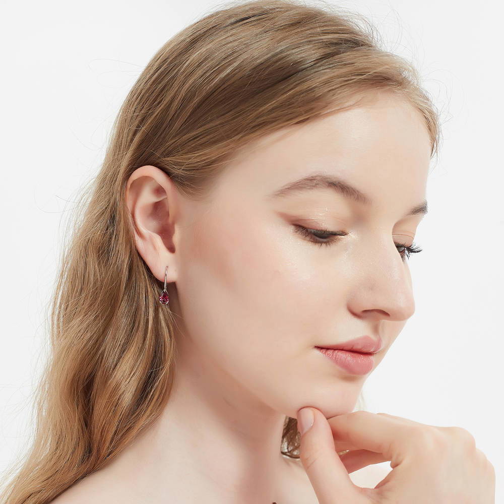 Model wearing Solitaire 1.6-2.6ct Pear CZ Leverback Earrings in Sterling Silver, Clear