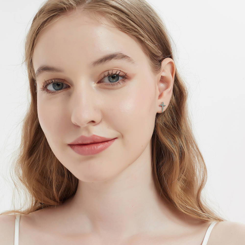 Model wearing Cross CZ Stud Earrings in Sterling Silver, Green Color