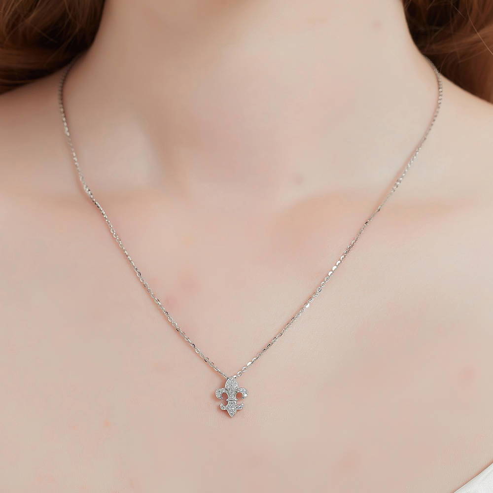 Model wearing Fleur De Lis CZ Necklace and Earrings in Sterling Silver, 10 of 15